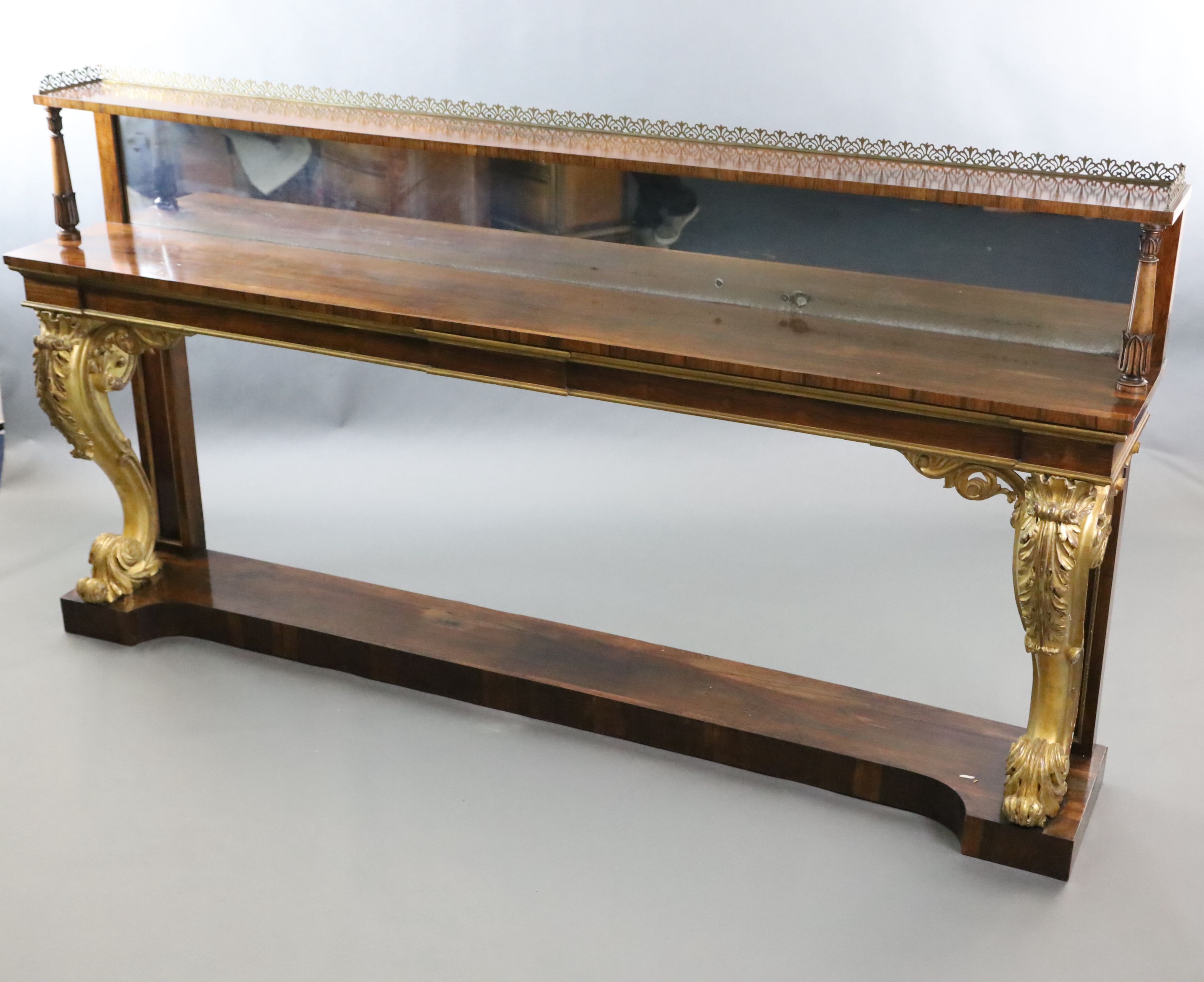 A pair of William IV parcel gilt rosewood console tables, W.8ft 2in. D.1ft 4in. H.4ft 4in.
